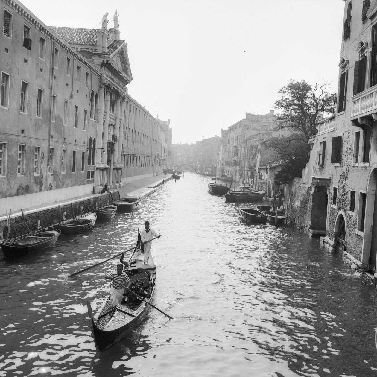Gondoliers sur un canal à Venise - Italian Photographer